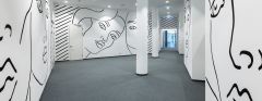 A white wall, where faces are painted.