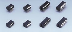 Eight DIP switches in different sizes on grey background.